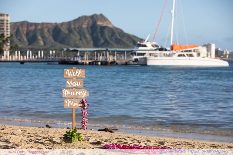 Surprise beach proposal with Diamond Head in the background Hawaii