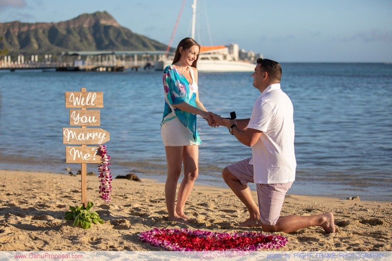 Surprise beach proposal with Diamond Head in the background Hawaii