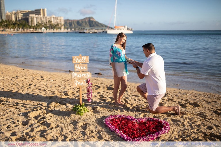 Surprise beach proposal with Diamond Head in the background Hawaii