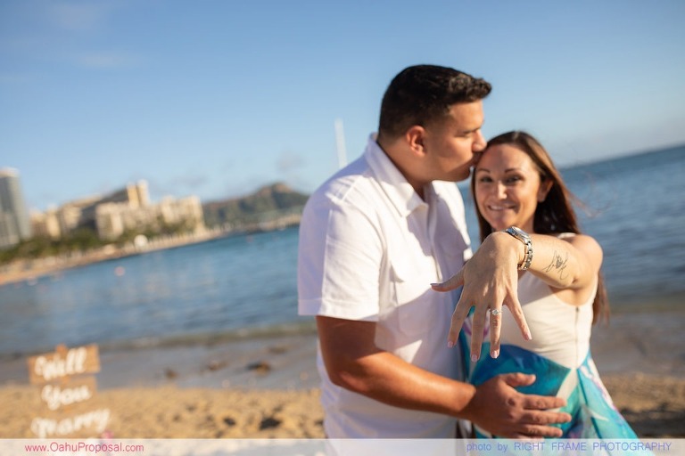 Surprise beach proposal with Diamond Head in the background Hawaii
